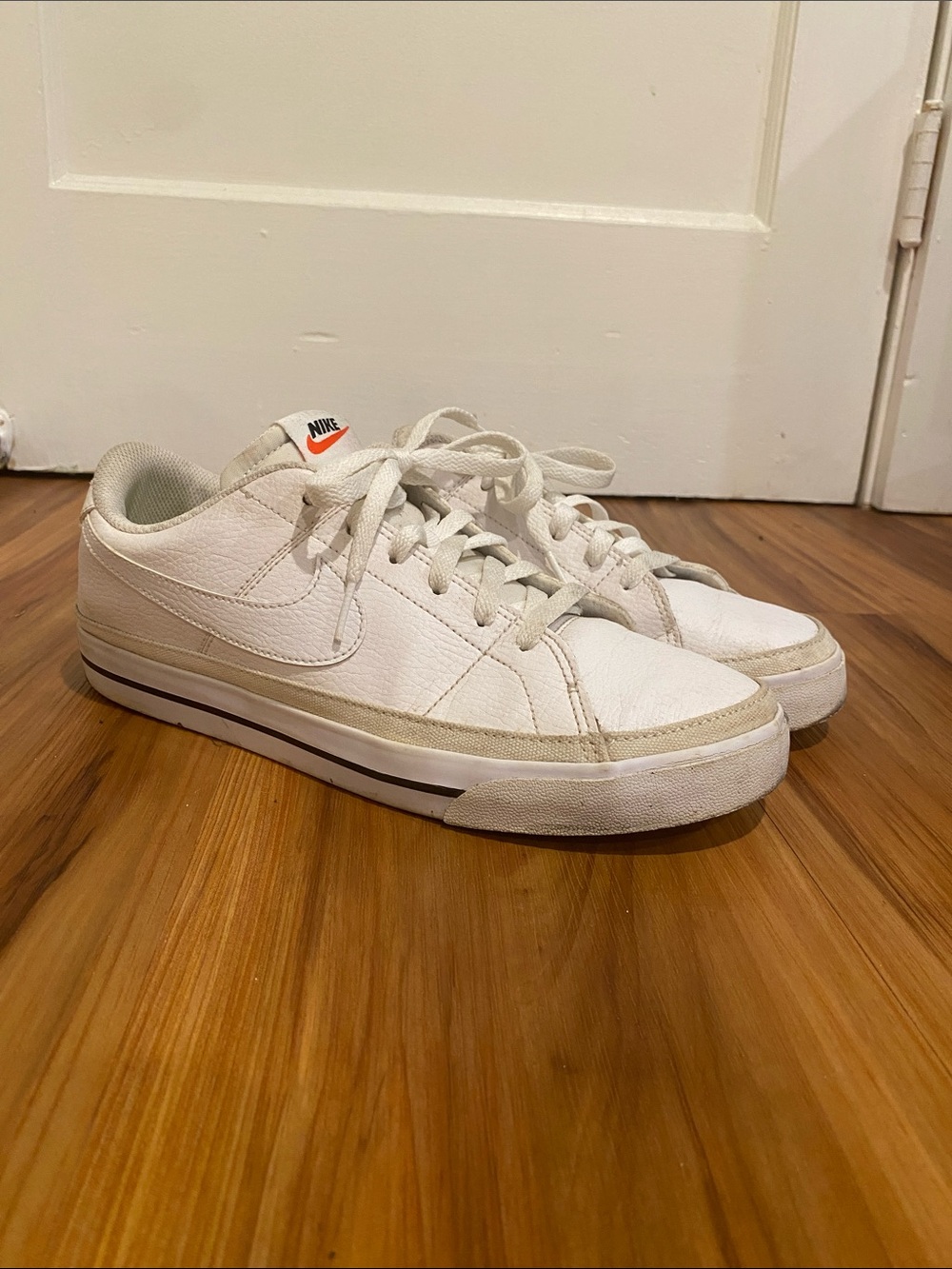 Nike Women's White Low-Top Sneakers with Orange Logo Accent